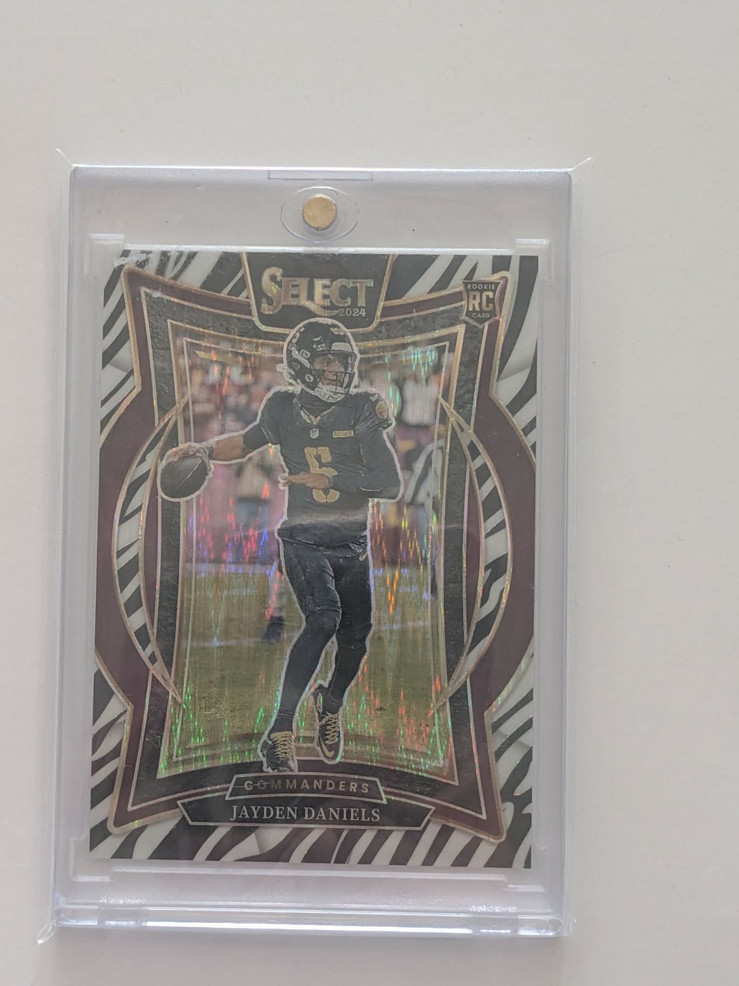 Jayden Daniels – 2024 Panini Select Concourse Zebra Shock SSP RC (No. 26)
